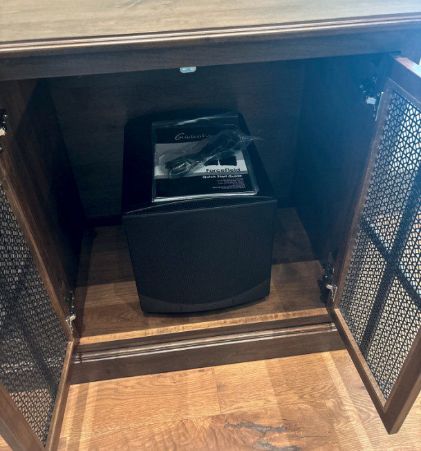 Speaker system stored inside wooden cabinet