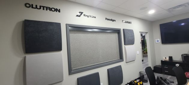 Wall display with Lutron and Paradigm logos